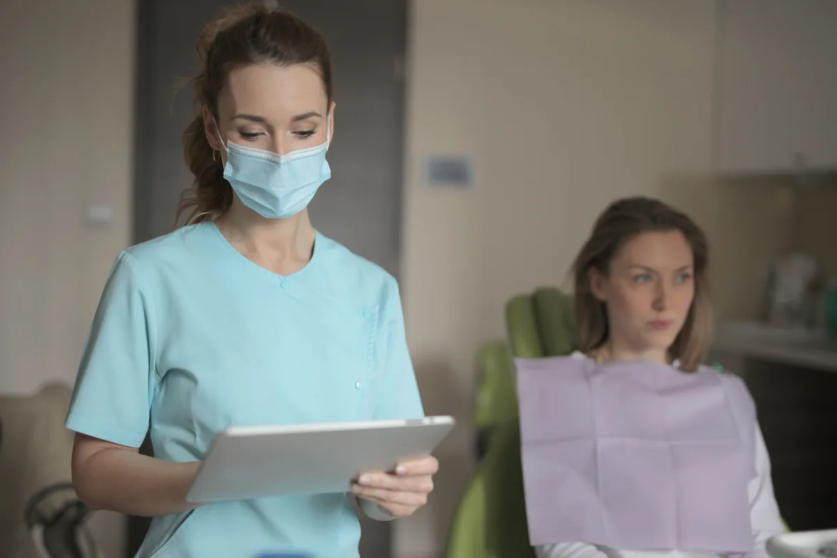 Clinician confirming upcoming appointments on a tablet between patient visits
