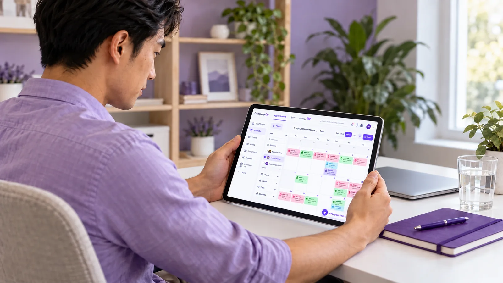 A home care coordinator reviewing a client care plan on a tablet at a clean desk
